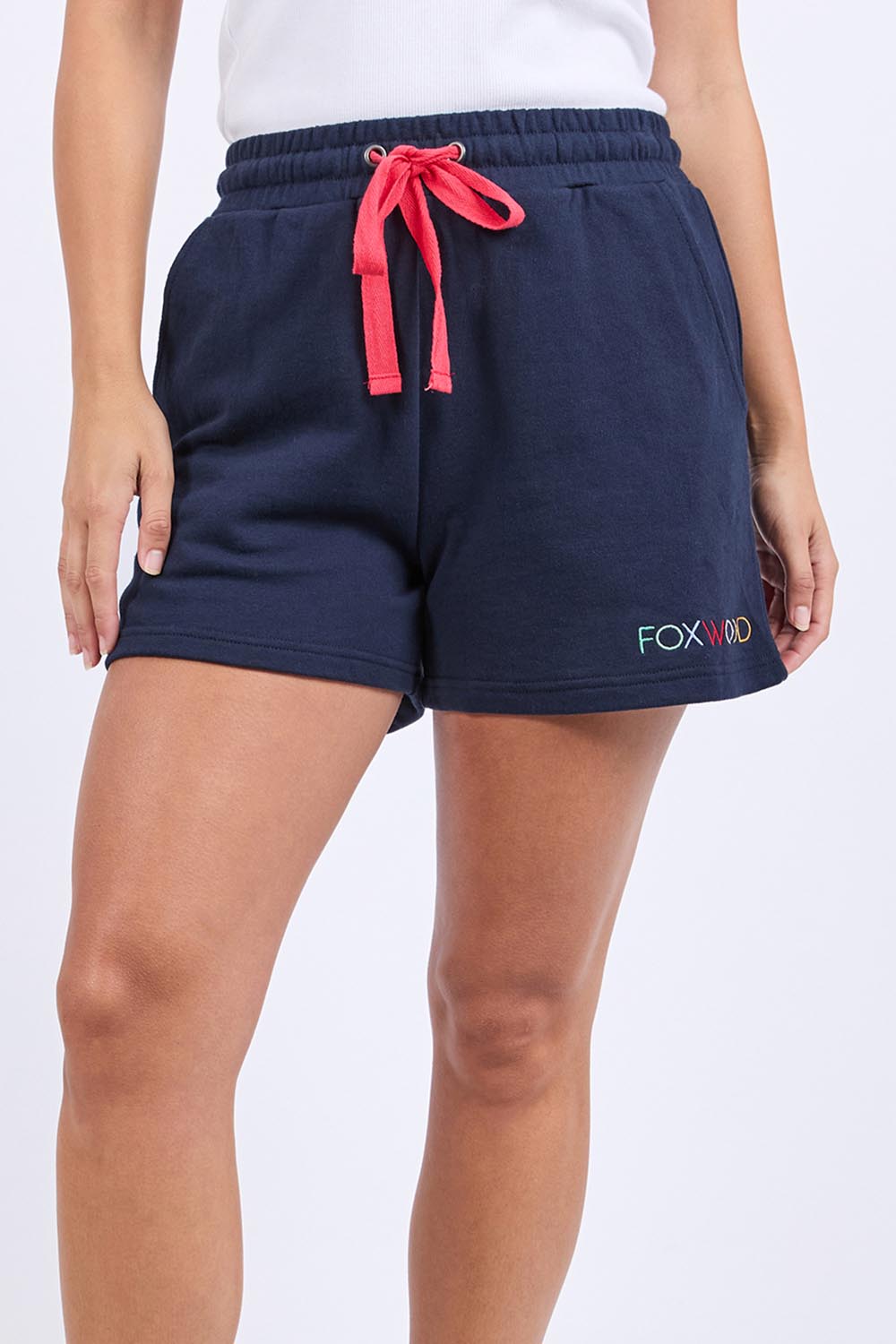 A model wearing the Elements Simplified Confetti Cotton Shorts in colour Navy (Blue), from the front, cropped image