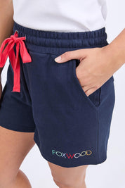 A model wearing the Elements Simplified Confetti Cotton Shorts in colour Navy (Blue), from the front, cropped image