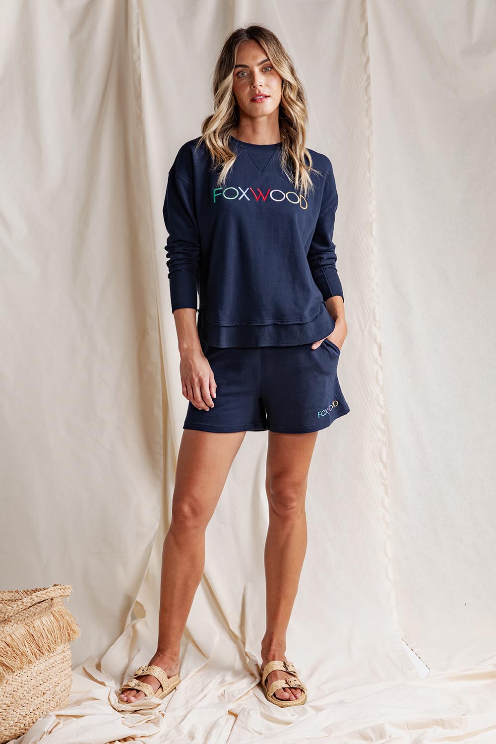 A model wearing the Elements Simplified Confetti Cotton Shorts in colour Navy (Blue), from the front, showing the whole outfit