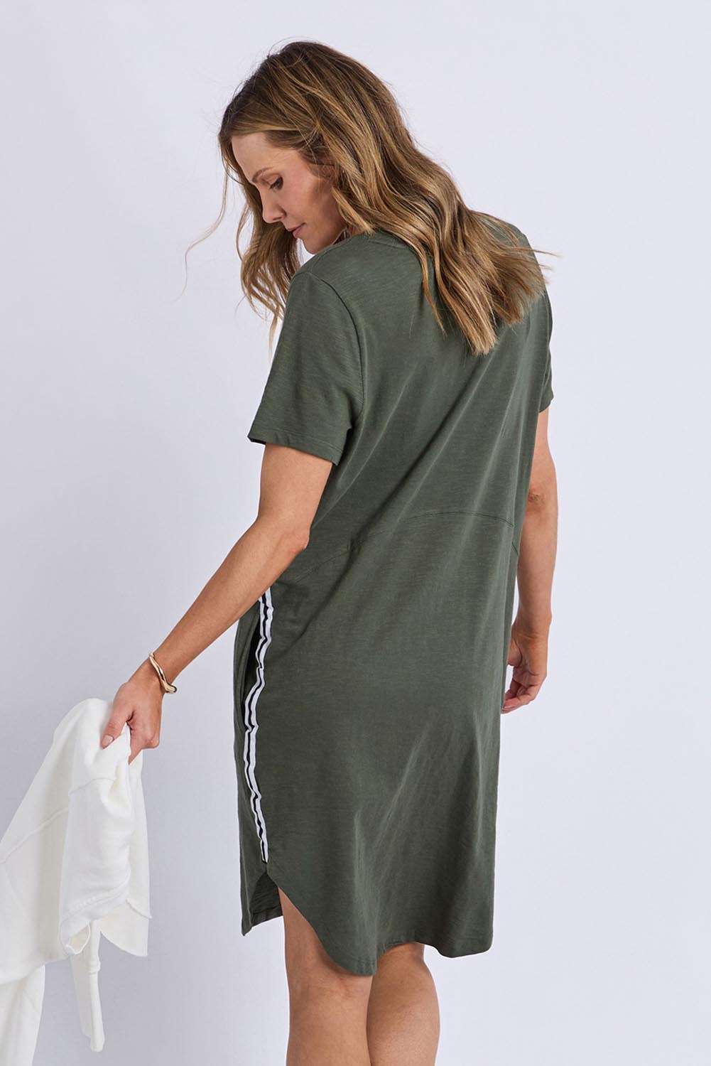 A model wearing the Elements Bay Tape Cotton Tee Dress in colour Khaki (Green), from the back