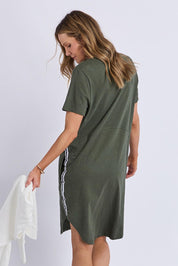 A model wearing the Elements Bay Tape Cotton Tee Dress in colour Khaki (Green), from the back