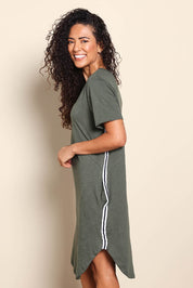 Model Pamelar wearing size 10 of the Elements Bay Tape Cotton Tee Dress - Khaki in colour Khaki, from an angle