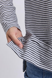 A model wearing the Elements Eddie Stripe Long Sleeve in colour Blackwhite (Black), from the front, cropped image