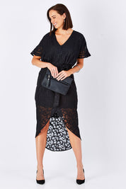 Model Perrie wearing size 10 of the Maylou Tie Waist Maxi Dress in colour BlackAntiq (Black), from the front, showing the whole outfit