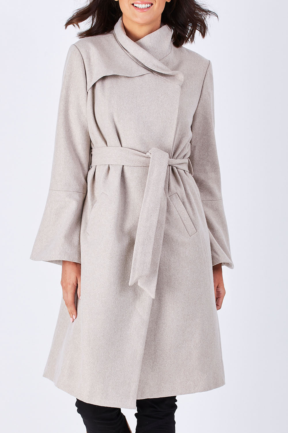 Model Perrie wearing size 10 of the Maniaa Long Coat in colour Chestnut, from the front, cropped image