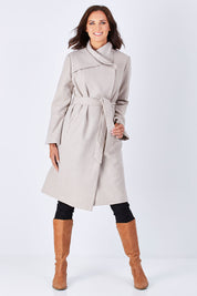 Model Perrie wearing size 10 of the Maniaa Long Coat in colour Chestnut, from the front, showing the whole outfit
