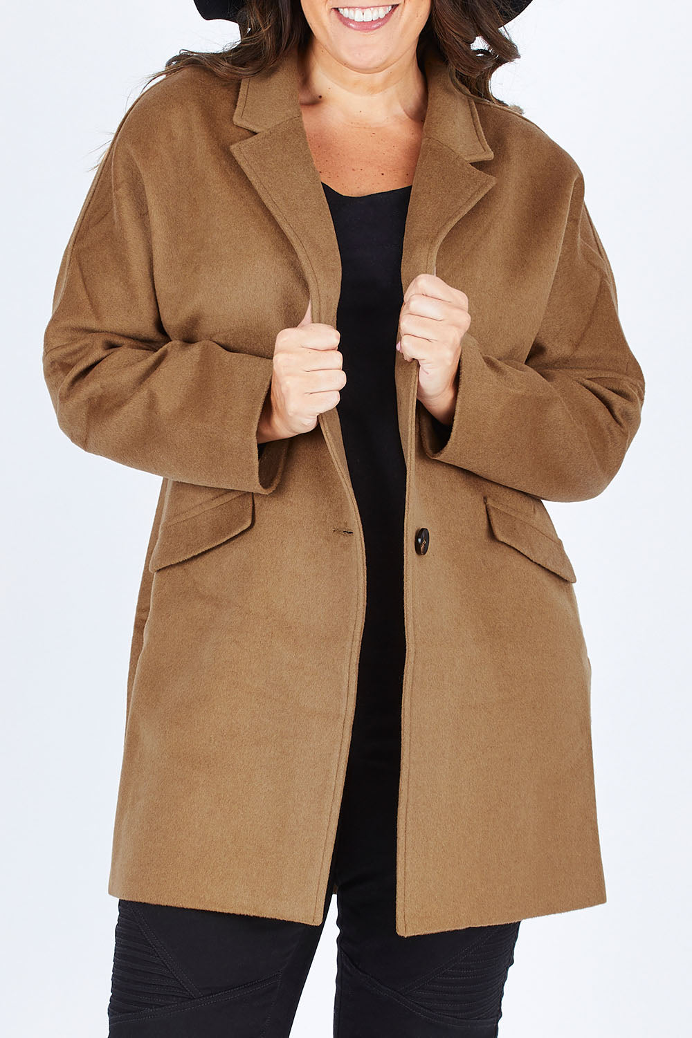 Model Stacey wearing size L of the Ascot Coat in colour Caramel, from the front, cropped image