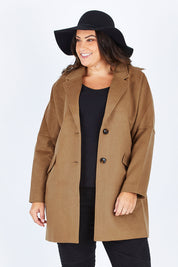 Model Stacey wearing size L of the Ascot Coat in colour Caramel, from the front, cropped image
