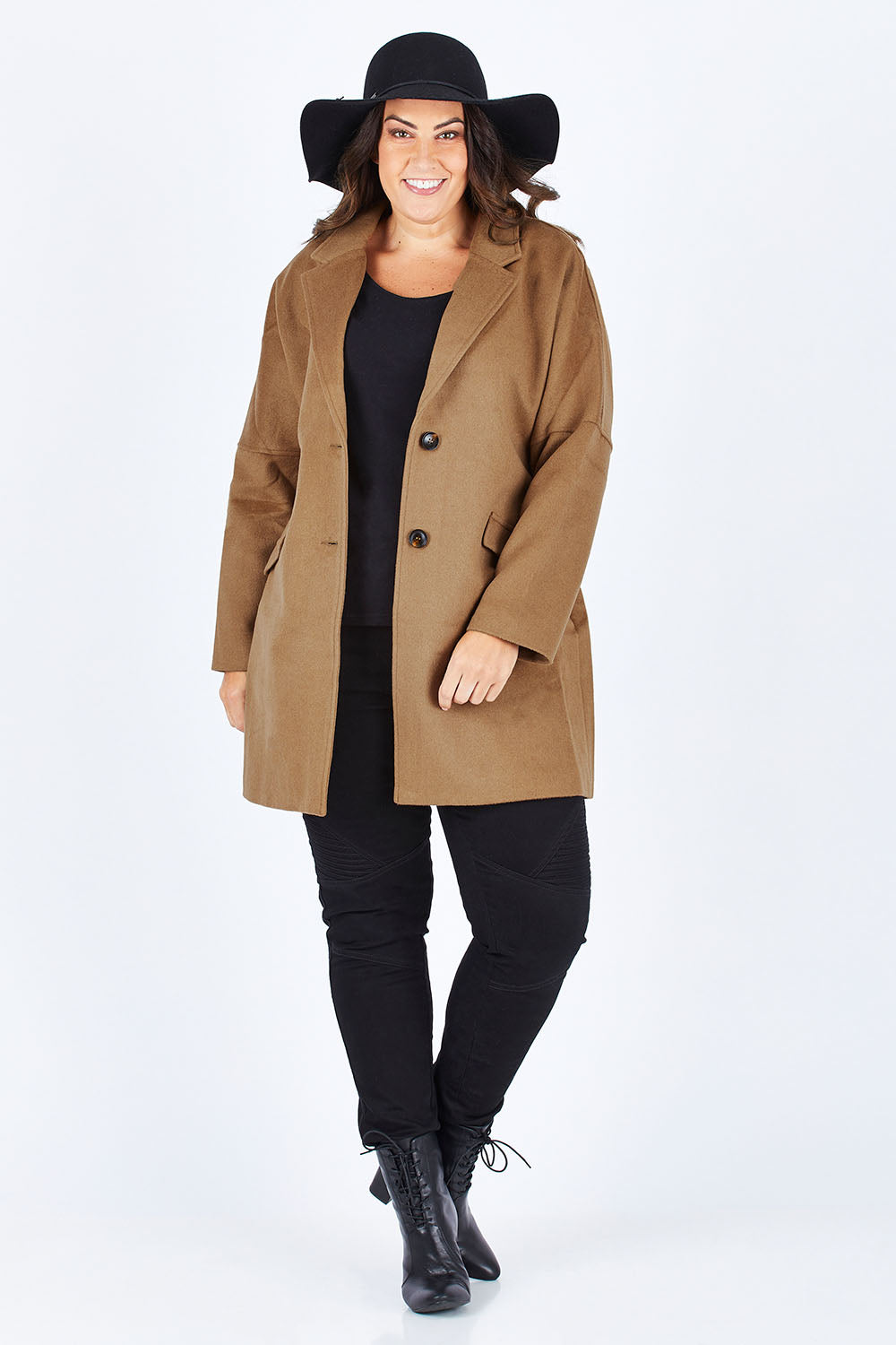 Model Stacey wearing size L of the Ascot Coat in colour Caramel, from the front, showing the whole outfit
