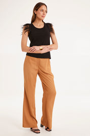 Model Madeline wearing size 10 of the Enchanted Top in colour Black (Black), from the front, showing the whole outfit