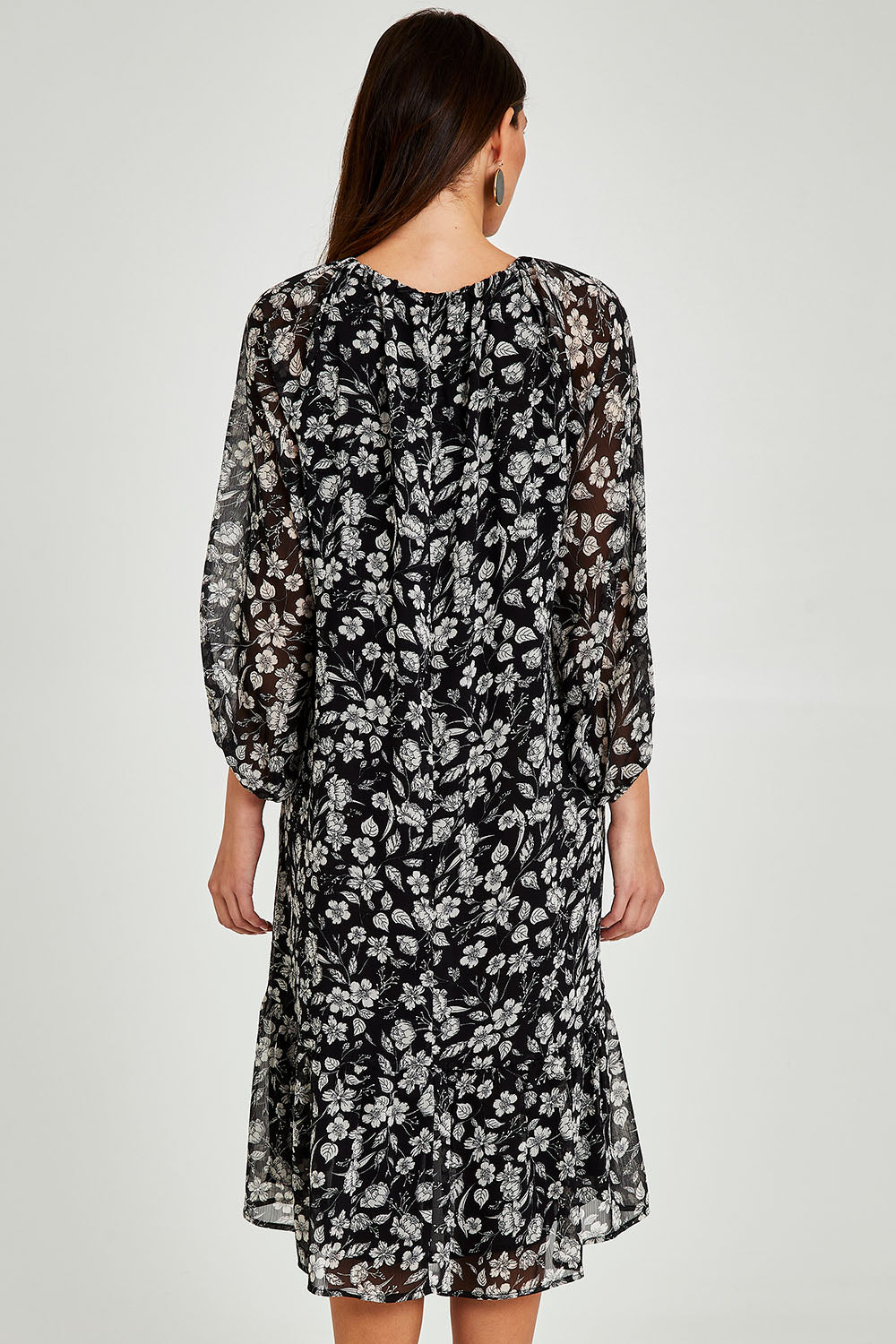 Model Madeline wearing size 10 of the Beautiful Soul Frill Hem Midi Dress in colour Monofloral (Black), from the back