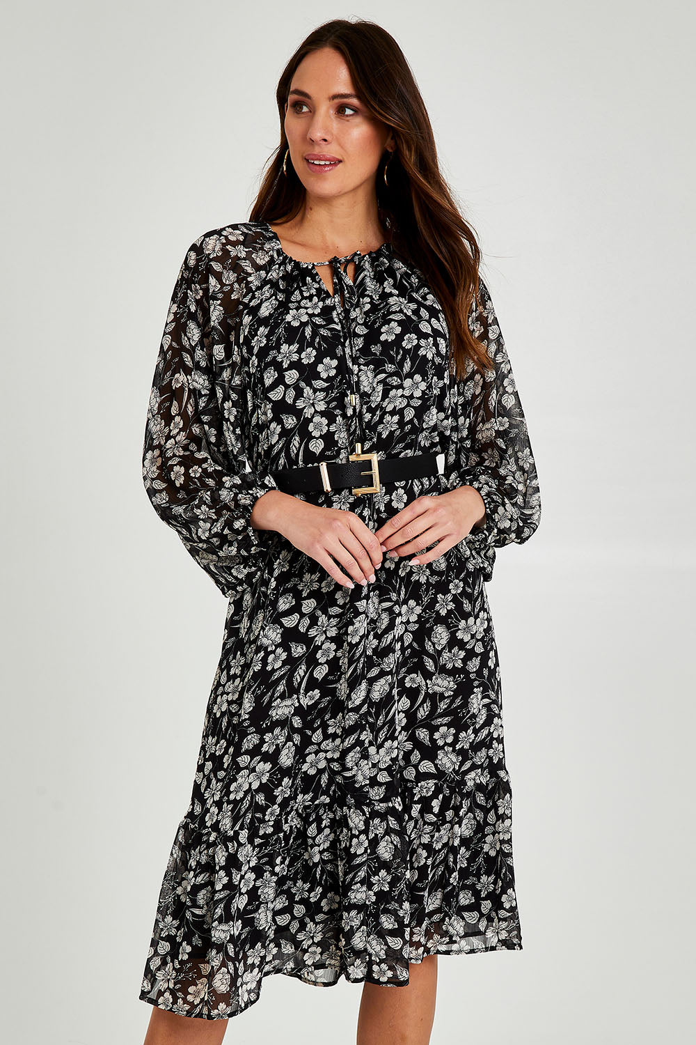 Model Madeline wearing size 10 of the Beautiful Soul Frill Hem Midi Dress in colour Monofloral (Black), from the front, cropped image