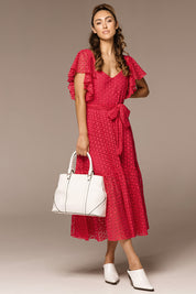 A model wearing the Dream Lover Broderie Midi Dress in colour Rubypink (Pink), from the front, showing the whole outfit