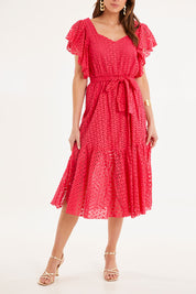 Model Madeline wearing size 10 of the Dream Lover Broderie Midi Dress in colour Rubypink (Pink), from the front, cropped image