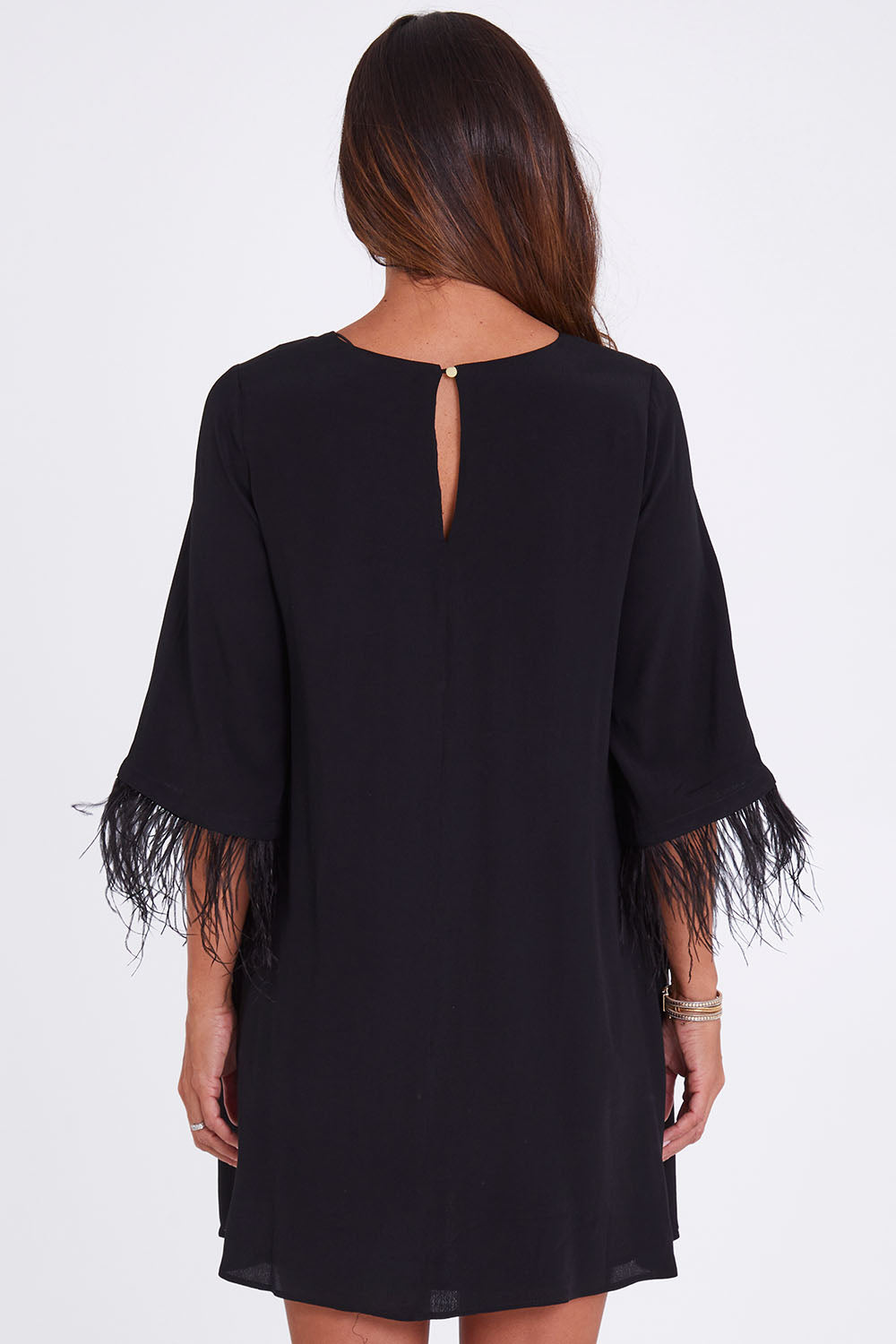 Model Alex wearing size 10 of the Enchanted Feather Sleeve Dress in colour Black (Black), from the back