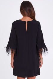 Model Alex wearing size 10 of the Enchanted Feather Sleeve Dress in colour Black (Black), from the back