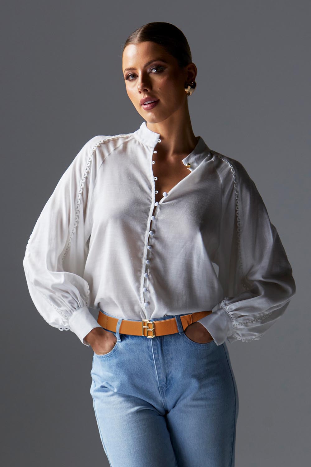 A model wearing the Berry Kiss Linen Tencel Blend Blouse in colour Ivory (White), from the front, showing the whole outfit