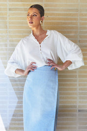 A model wearing the Berry Kiss Linen Tencel Blend Blouse in colour Ivory (White), from the front, showing the whole outfit