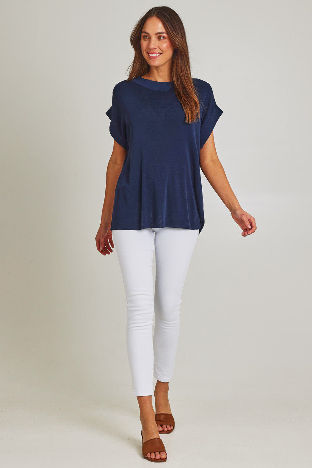 Model Madeline wearing size 10 of the Junos Knit in colour Navy (Blue), from the front, showing the whole outfit