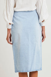 Model Madeline wearing size 10 of the Flight Denim Wrap Skirt in colour Wash (Blue), from the back