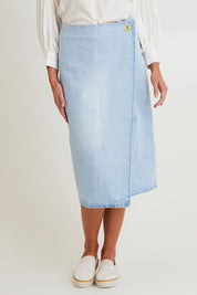 Model Madeline wearing size 10 of the Flight Denim Wrap Skirt in colour Wash (Blue), from the front, cropped image