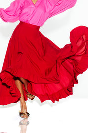 A model wearing the All Night Long Skirt in colour Lipstick (Red), from the front, cropped image