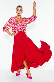 A model wearing the All Night Long Skirt in colour Lipstick (Red), from the front, showing the whole outfit