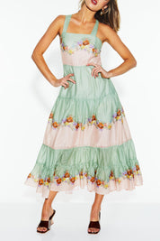 A model wearing the Hollyhock Cotton Voile Maxi Dress in colour Floraleye (Green), from the front, cropped image