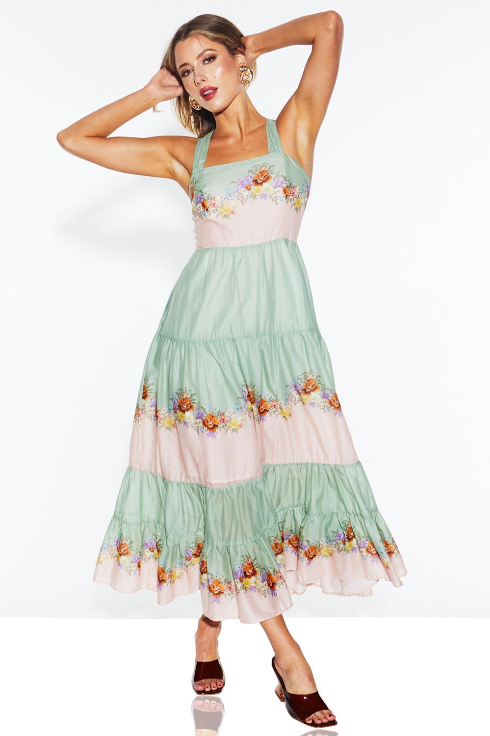 A model wearing the Hollyhock Cotton Voile Maxi Dress in colour Floraleye (Green), from the front, showing the whole outfit