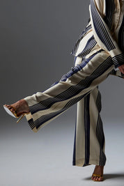 A model wearing the Heartstopper Pant in colour Navystripe (Blue), from the front, showing the whole outfit