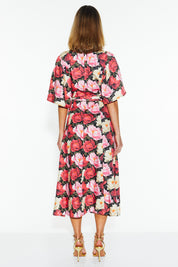 A model wearing the Lyrical Lyocell Midi Dress in colour Oscarflora (Pink), from the back