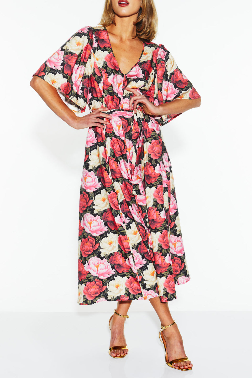 A model wearing the Lyrical Lyocell Midi Dress in colour Oscarflora (Pink), from the front, cropped image
