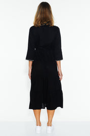 A model wearing the Showcase Tencel Blend Dress in colour Black (Black), from the back