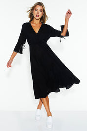A model wearing the Showcase Tencel Blend Dress in colour Black (Black), from the front, showing the whole outfit