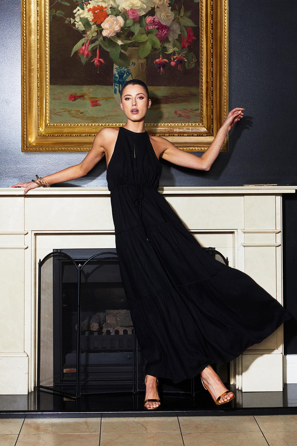 A model wearing the Midsummer Halter Linen Blend Maxi Dress in colour Black (Black), from the front, showing the whole outfit