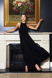 A model wearing the Midsummer Halter Linen Blend Maxi Dress in colour Black (Black), from the front, showing the whole outfit