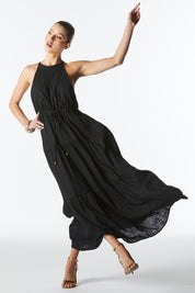 A model wearing the Midsummer Halter Linen Blend Maxi Dress in colour Black (Black), from the front, showing the whole outfit