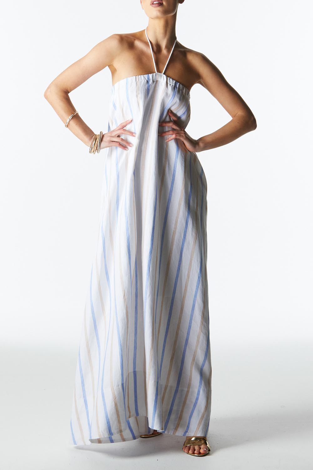 A model wearing the Poolside Boxy Linen Dress in colour Stripe (Blue), from the front, cropped image