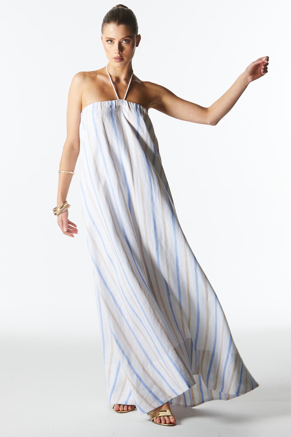 A model wearing the Poolside Boxy Linen Dress in colour Stripe (Blue), from the front, showing the whole outfit