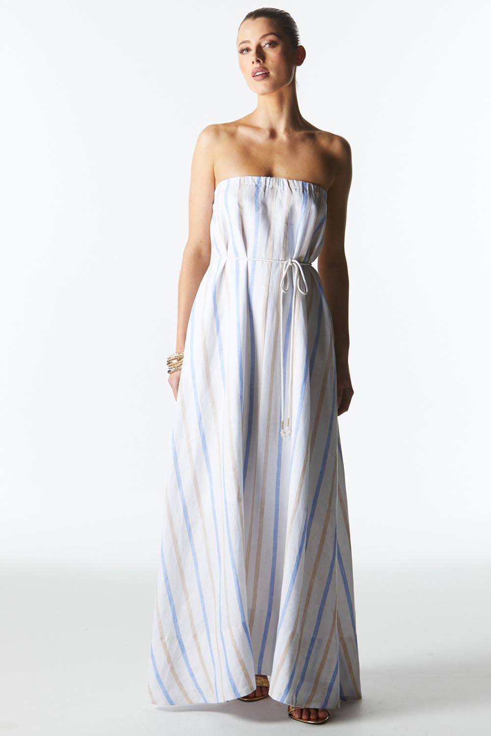 A model wearing the Poolside Boxy Linen Dress in colour Stripe (Blue), from the front, showing the whole outfit