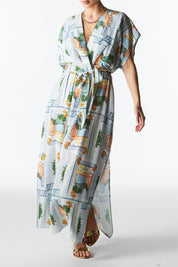 A model wearing The Terrace Linen Cotton Dress in colour Postcard (Blue), from the front, cropped image