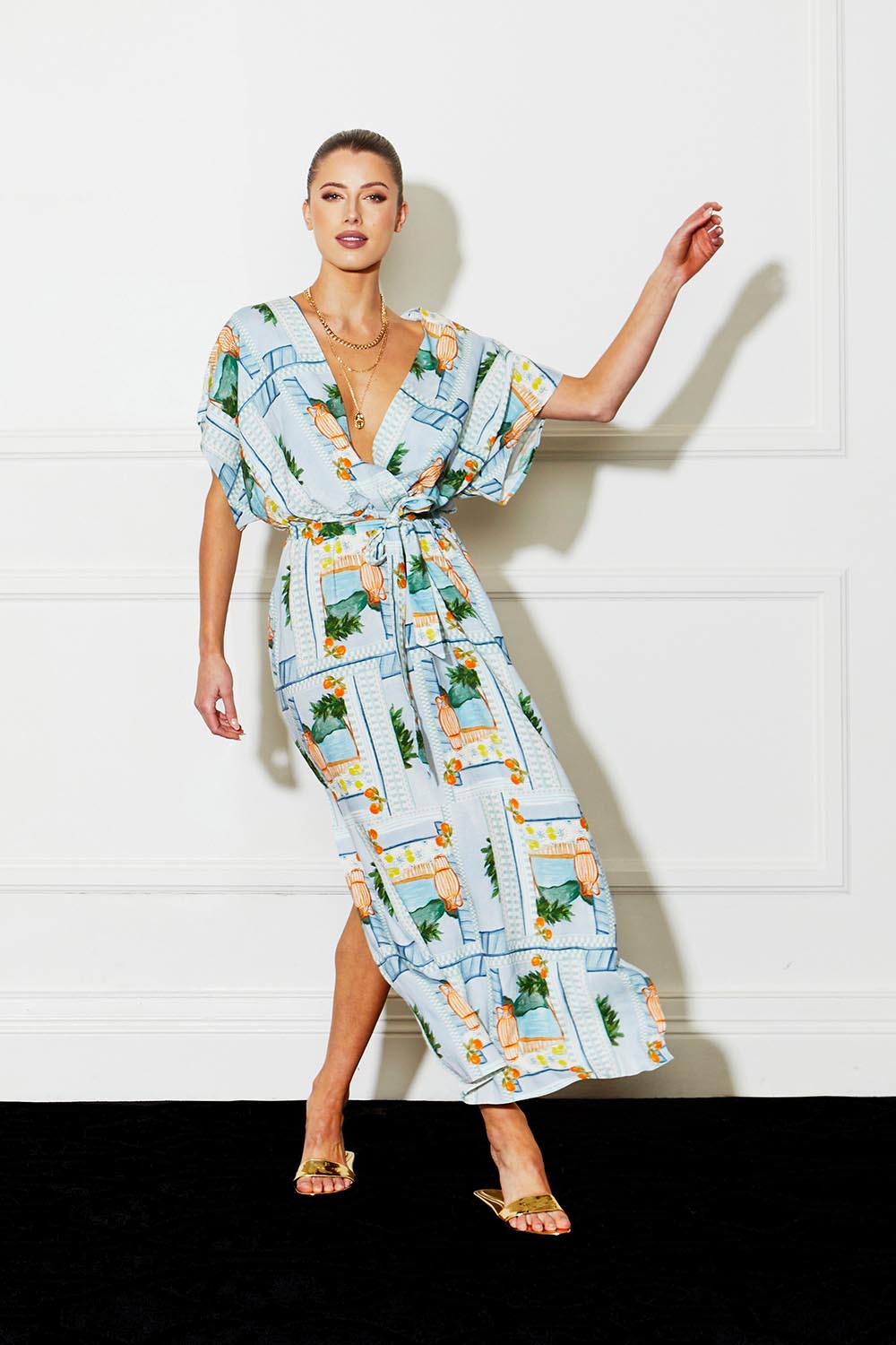 A model wearing The Terrace Linen Cotton Dress in colour Postcard (Blue), from the front, showing the whole outfit