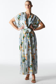 A model wearing The Terrace Linen Cotton Dress in colour Postcard (Blue), from the front, showing the whole outfit