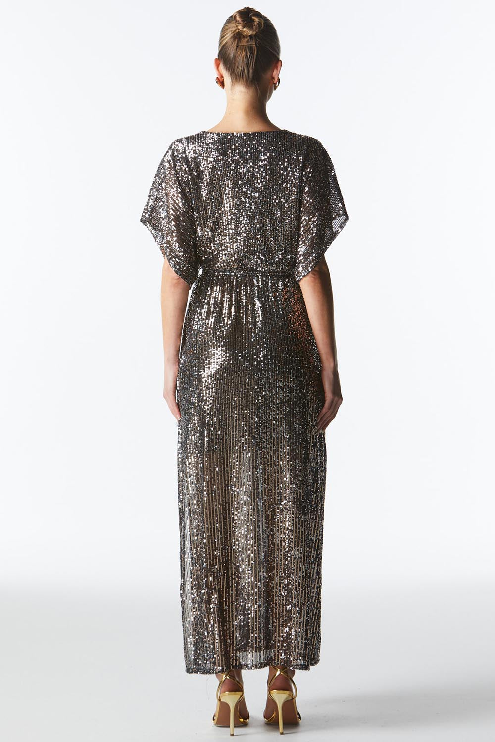 A model wearing the Impression Sequin Dress in colour Gunmetal (Black), from the back