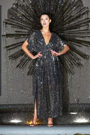 A model wearing the Impression Sequin Dress in colour Gunmetal (Black), from the front, showing the whole outfit