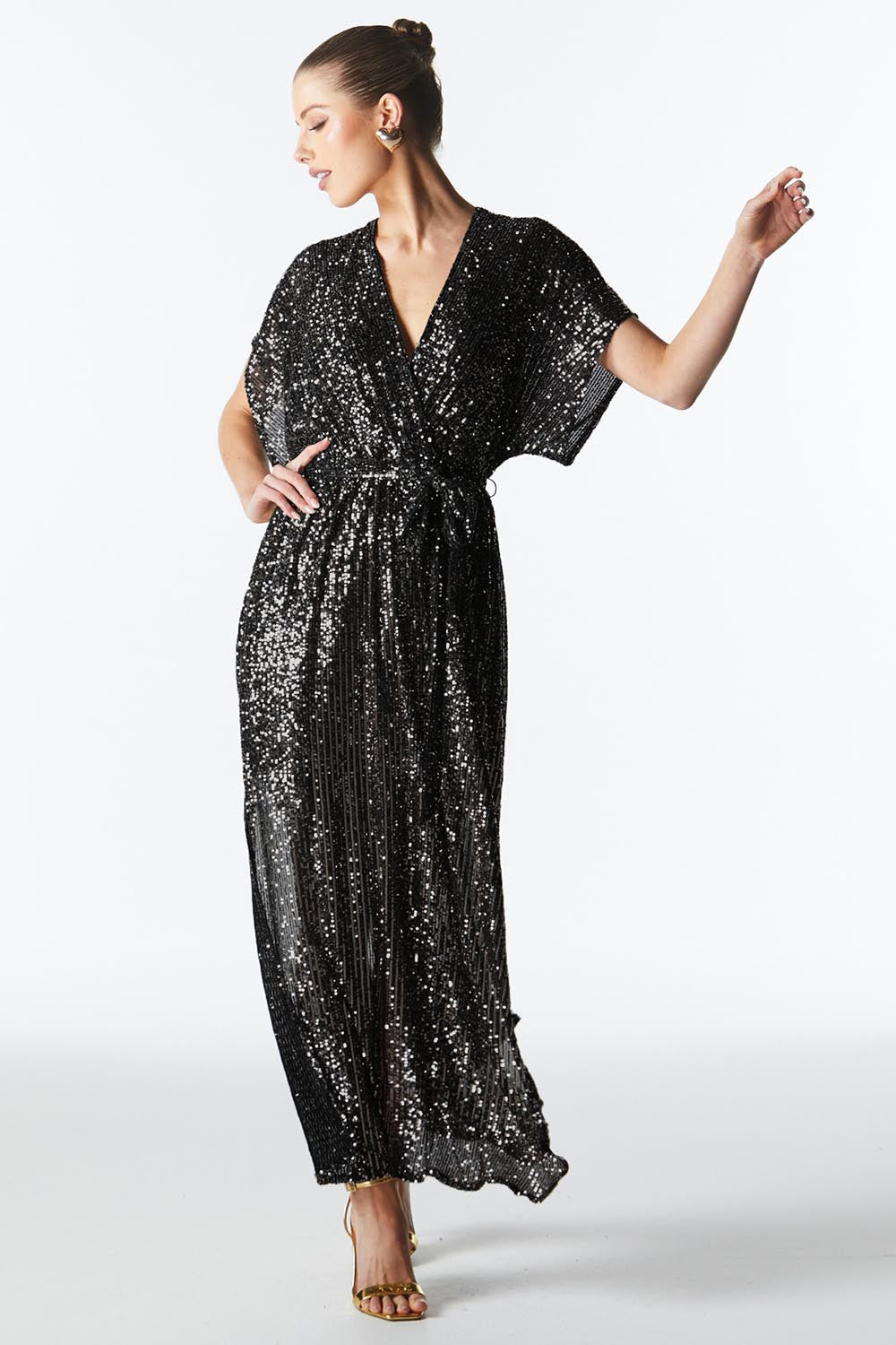 A model wearing the Impression Sequin Dress in colour Gunmetal (Black), from the front, showing the whole outfit
