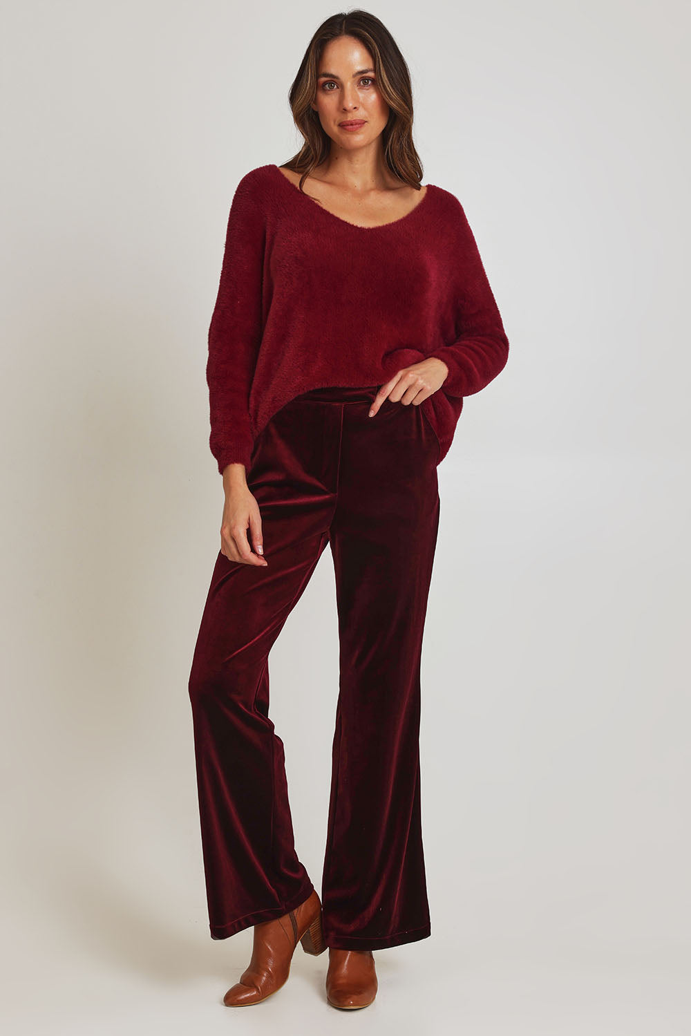 Model Madeline wearing size 10 of the Mustang Sally Velvet Pant in colour Wine (Red), from the front, showing the whole outfit