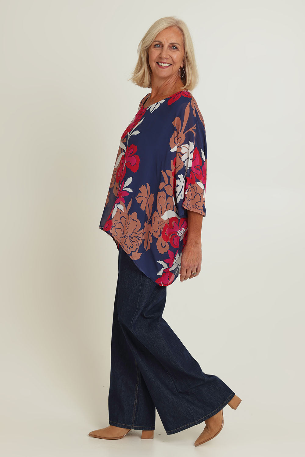 Model Sandy wearing size 10 of the Magnetic Fever Top in colour Pinkfloral (Blue), from the front, showing the whole outfit