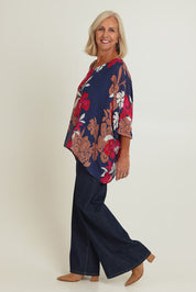 Model Sandy wearing size 10 of the Magnetic Fever Top in colour Pinkfloral (Blue), from the front, showing the whole outfit