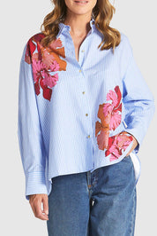 A model wearing the Sweet Jane Cotton Shirt in colour Stripe (Blue), from the front, cropped image